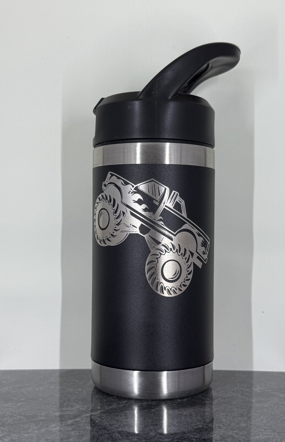 Black bottle with monster truck engraving