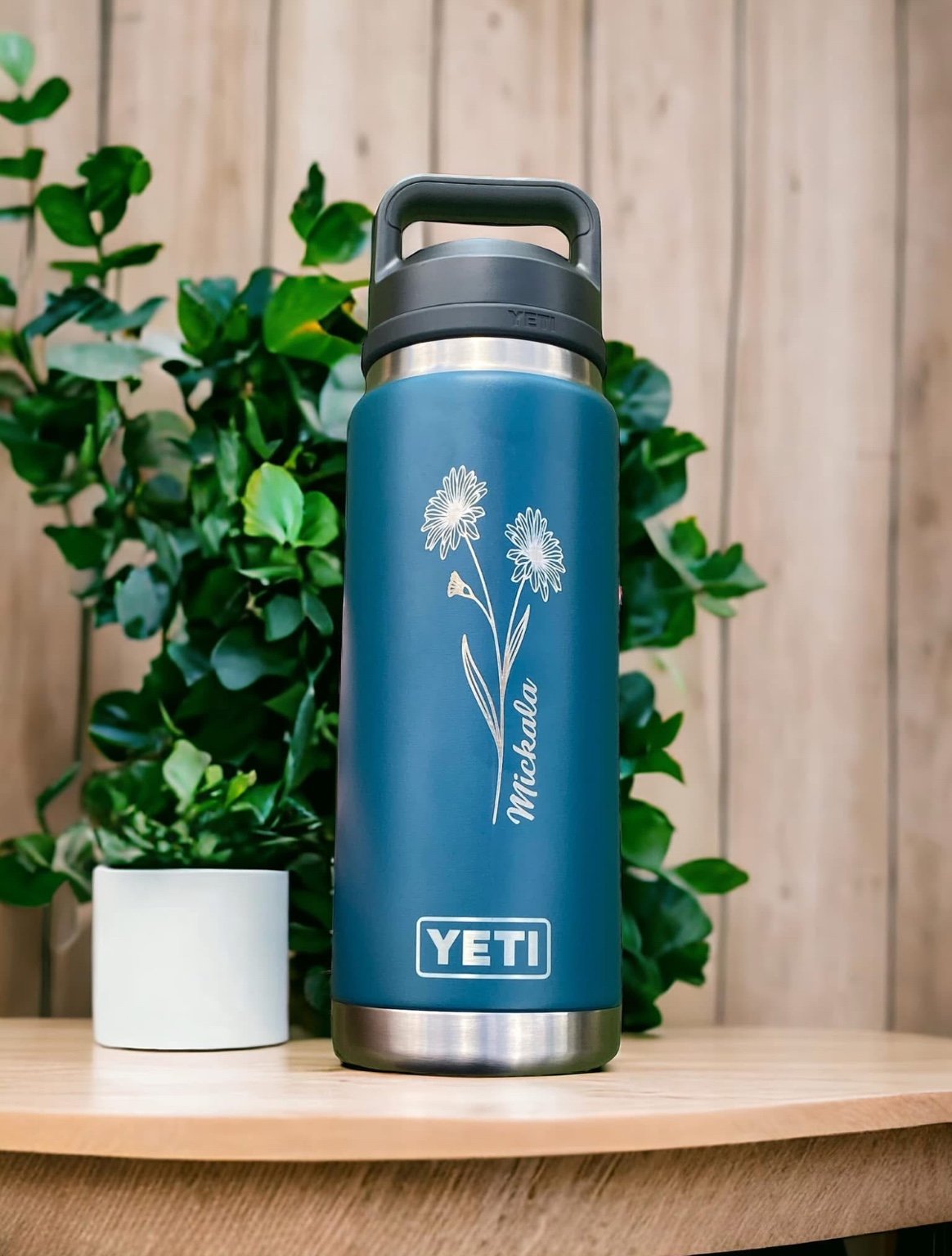 Blue bottle with wildflower engraving
