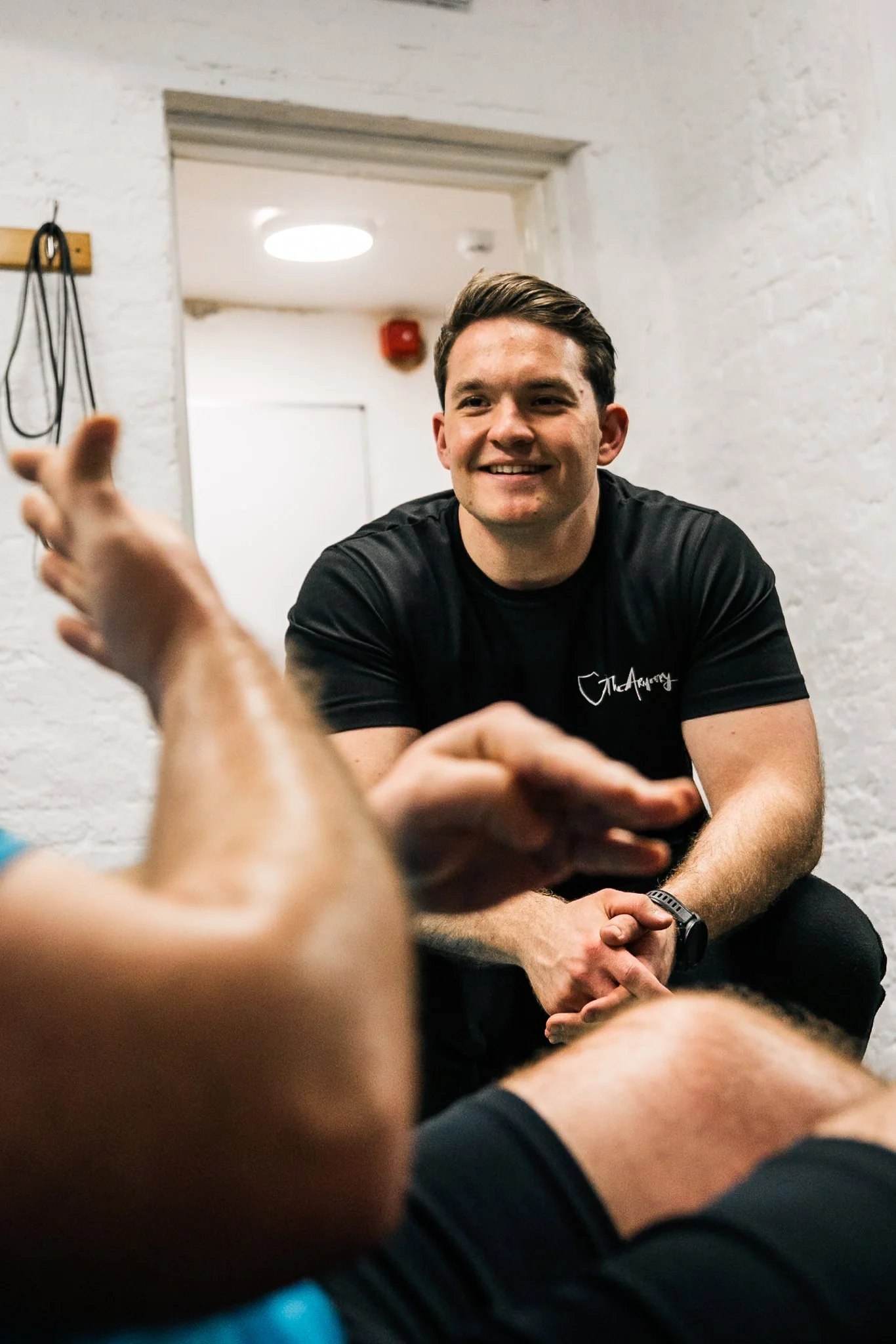 Personal trainer talking with a client at The Armoury