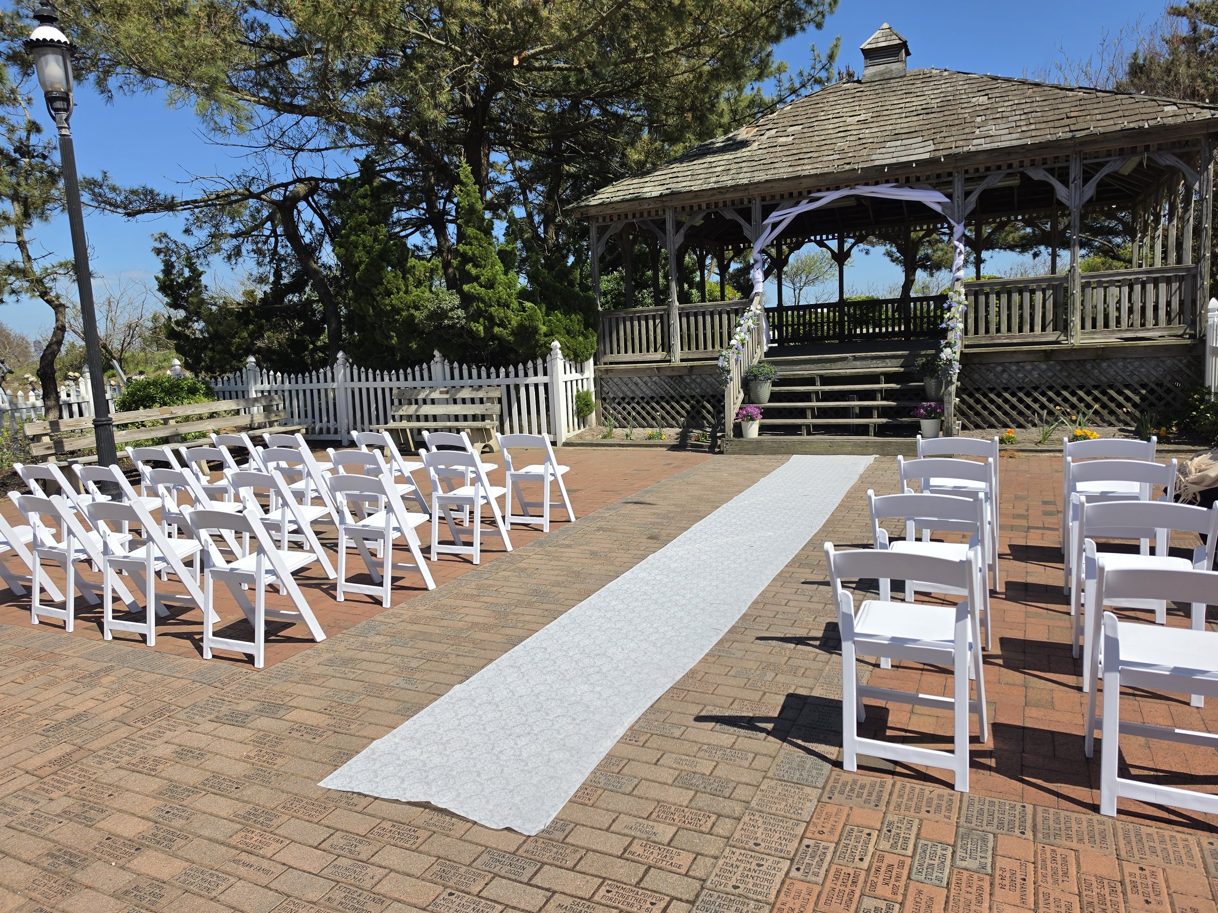 Cheers and Chairs waterfront gazebo wedding ceremony setup