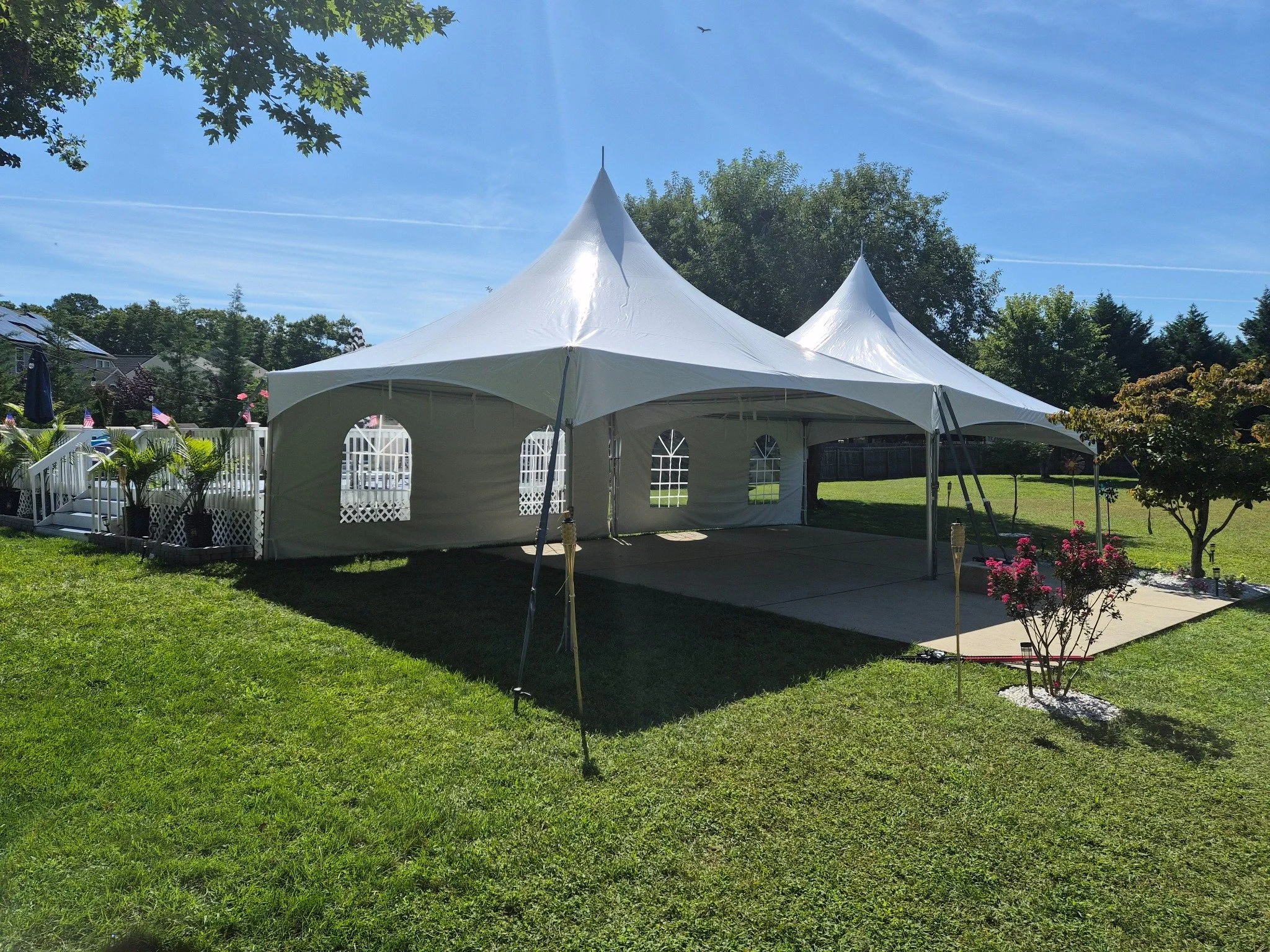 Real Cheers and Chairs installation of two connected white high-peak tents at a backyard event