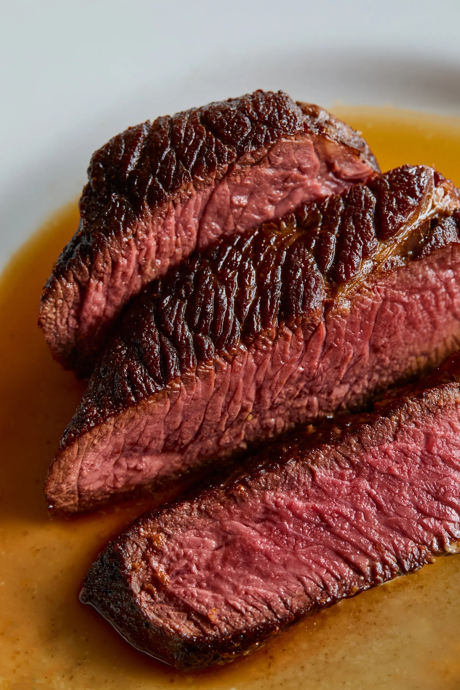 Sliced steak, cooked pink, with sauce
