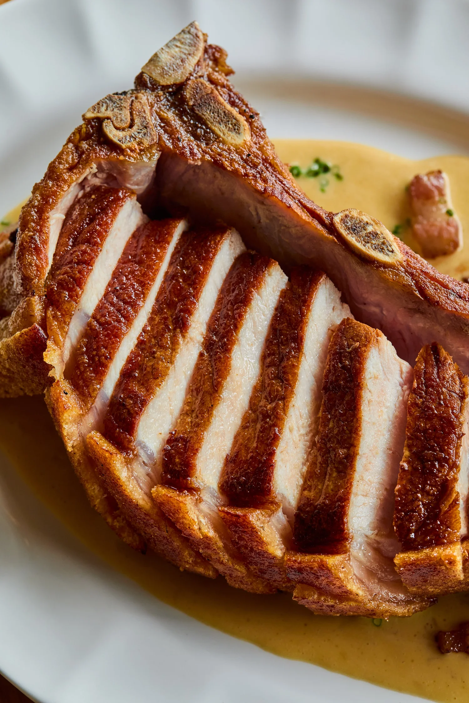 Sliced pork chop with crackling and sauce