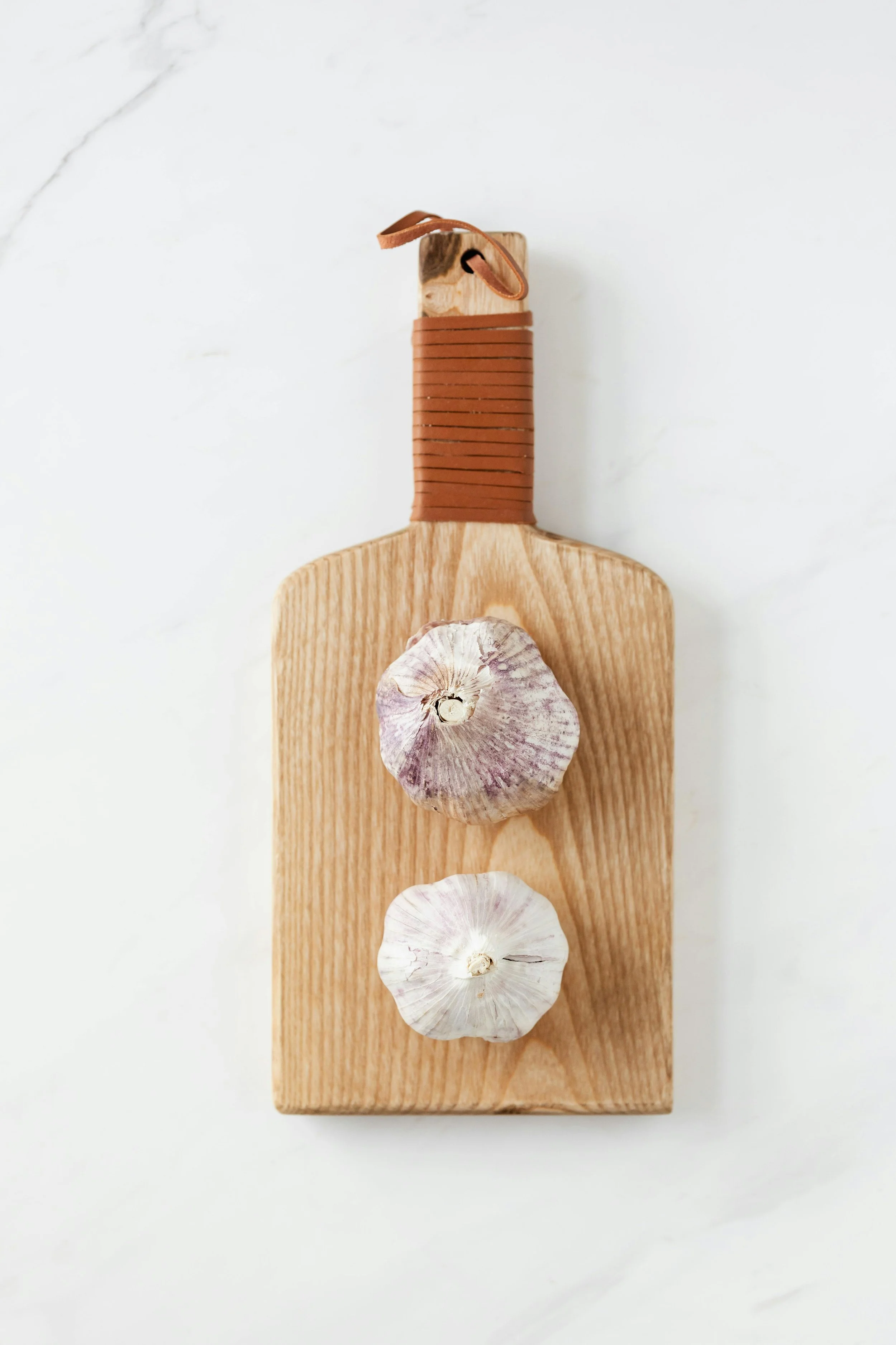 Fresh garlic bulbs and cloves arranged on a rustic surface
