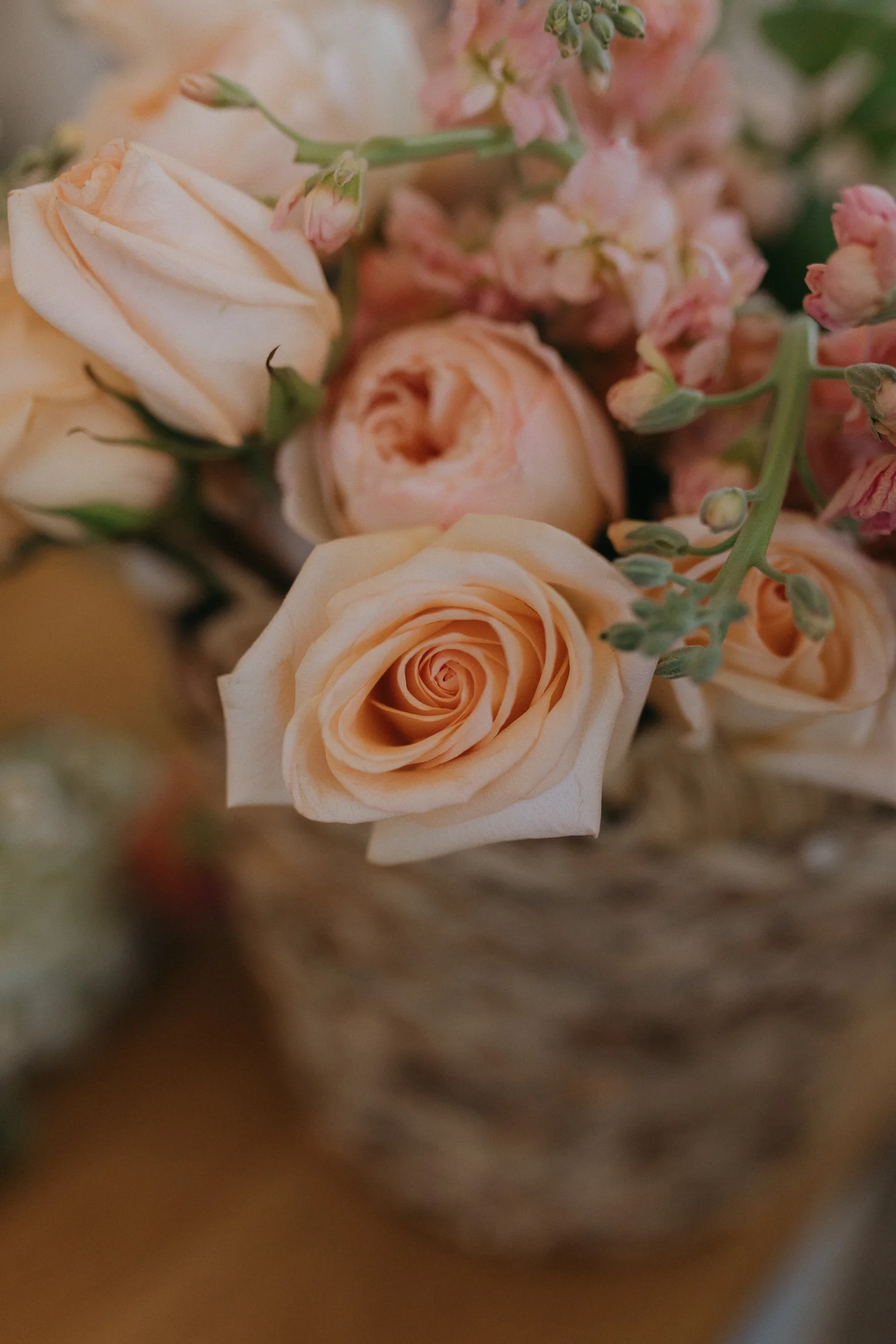 Peach roses and pink seasonal flowers