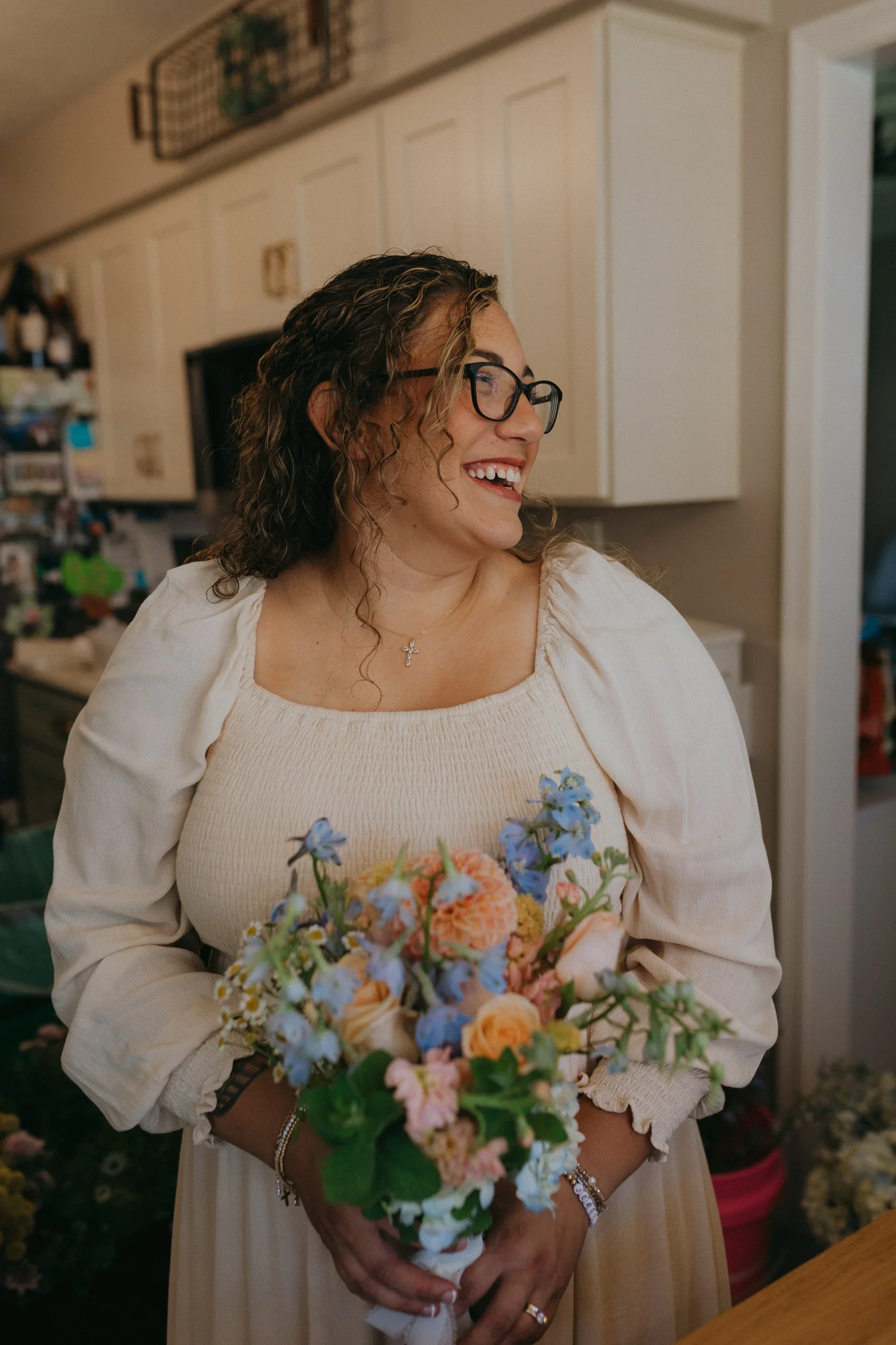 Motherhood in Blooms florist holding a locally inspired bouquet