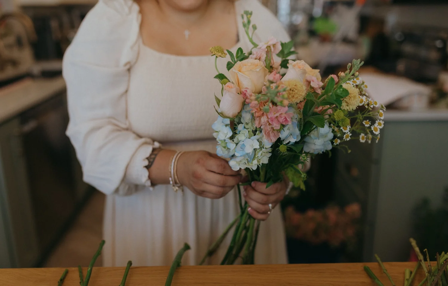 Florist holding a colorful garden-inspired bouquet