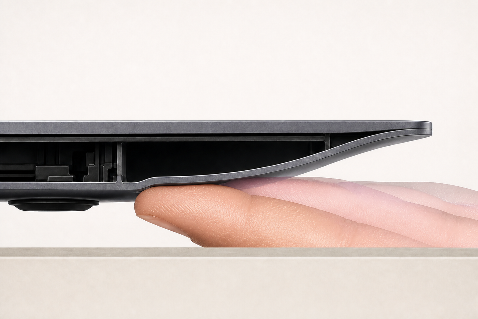 A side cutaway shows a finger pad supporting an open-ended underside slide and moving outward as the laptop descends