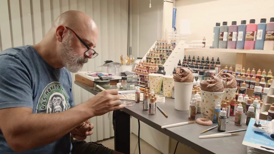 Animator and artist Len Simon working at his studio table