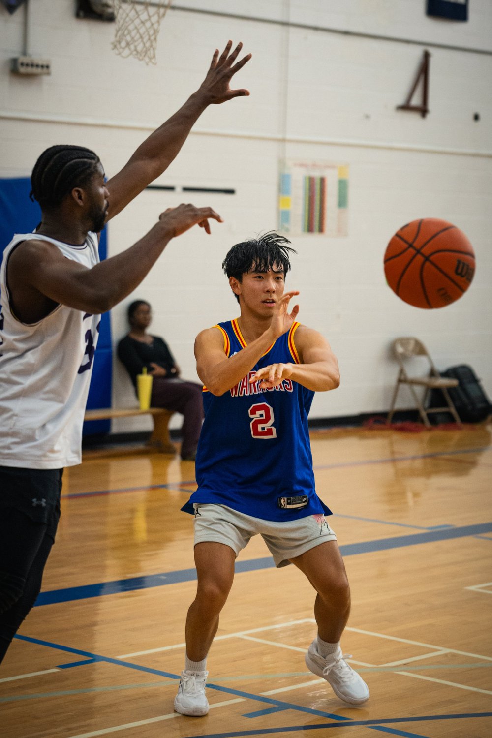 Warriors number 2 releases a pass as an Icons B defender raises one arm.