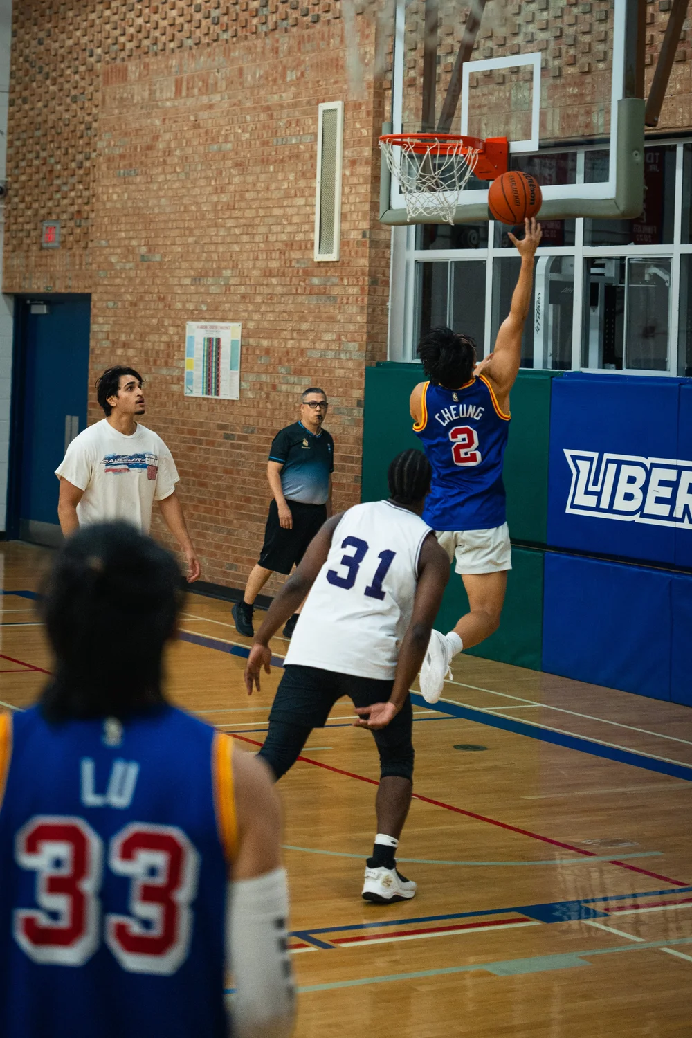 Warriors number 2 reaches up for a layup attempt as Icons B number 31 follows.
