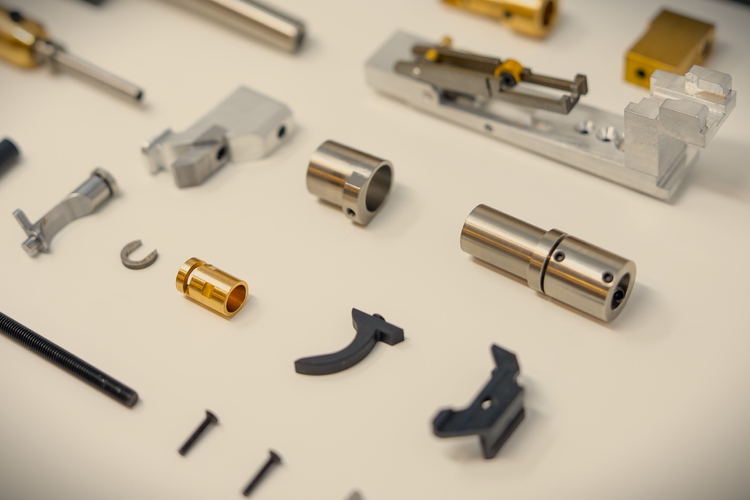 Machined metal components arranged on a light surface