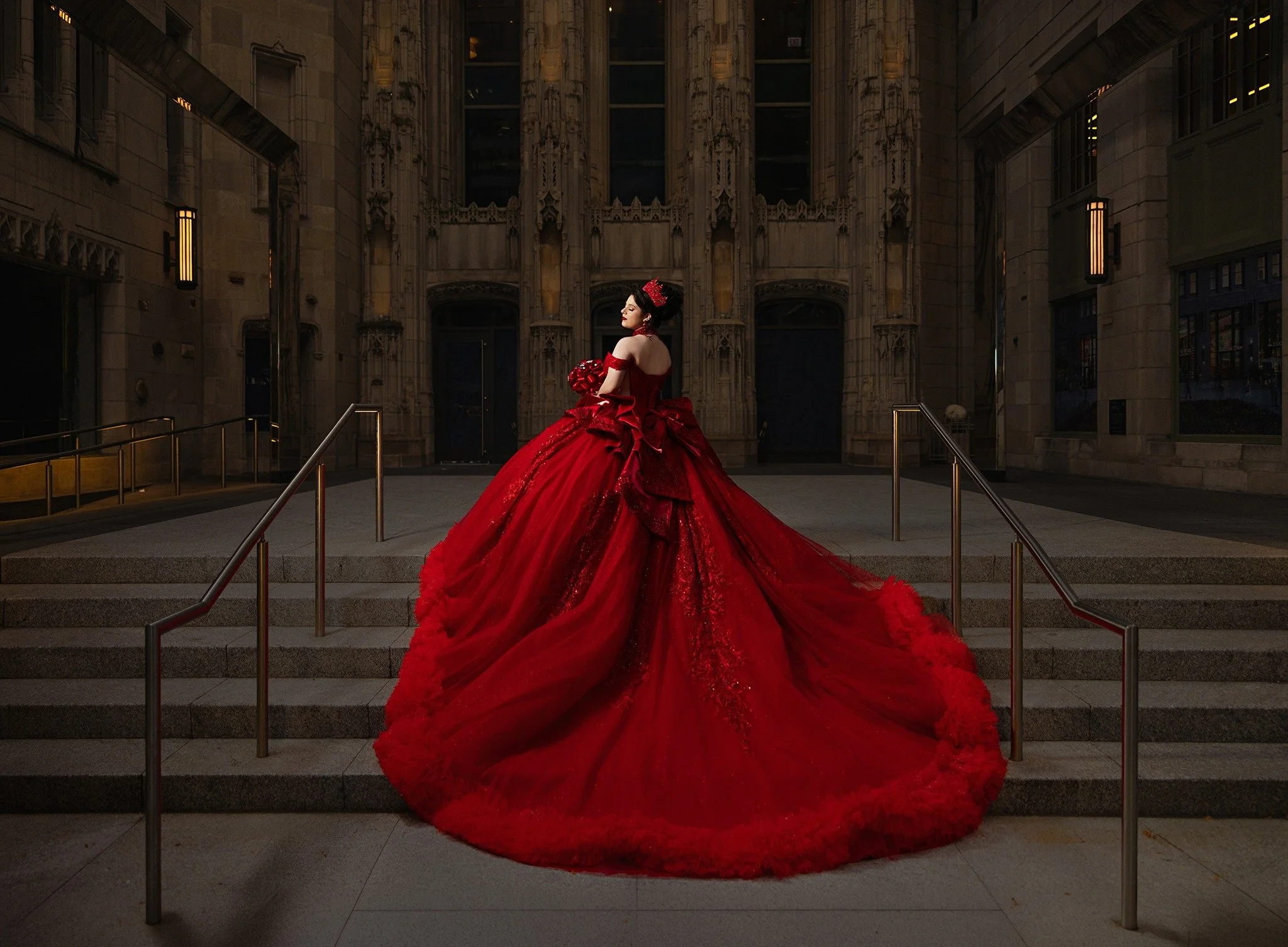 Audrey in an elegant red quinceañera gown on the steps of a historic Chicago building