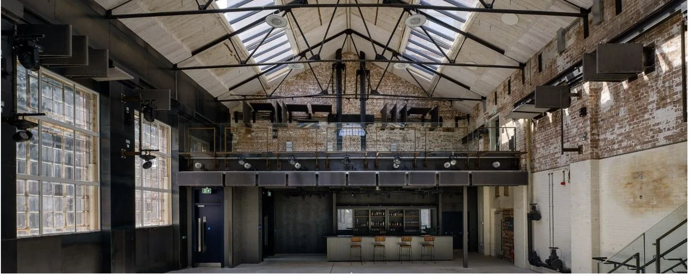 The Main Hall, with its glazed roof, brick walls, mezzanine and bar