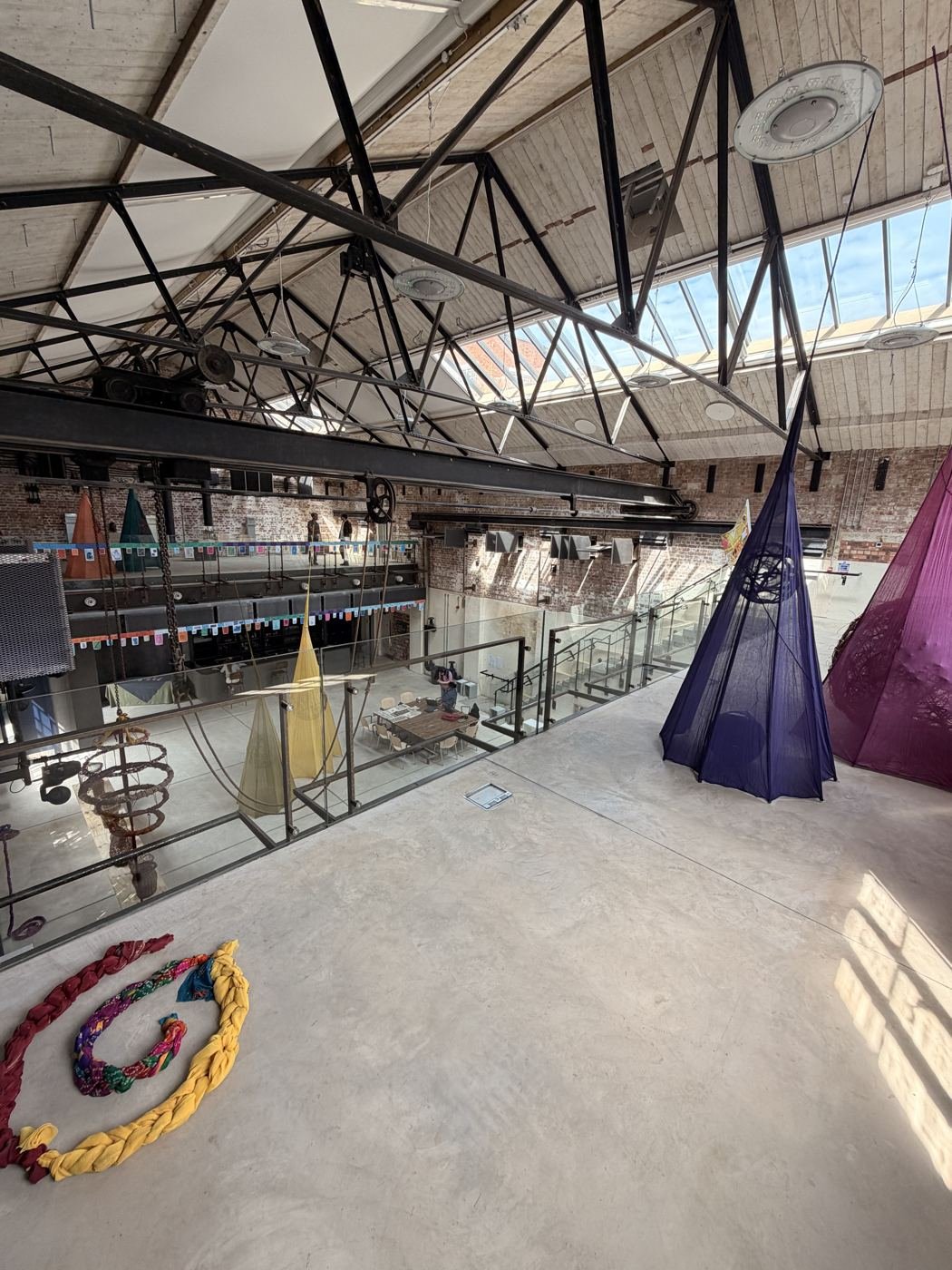 Switch Gear Gallery with hanging textile work and views across the building
