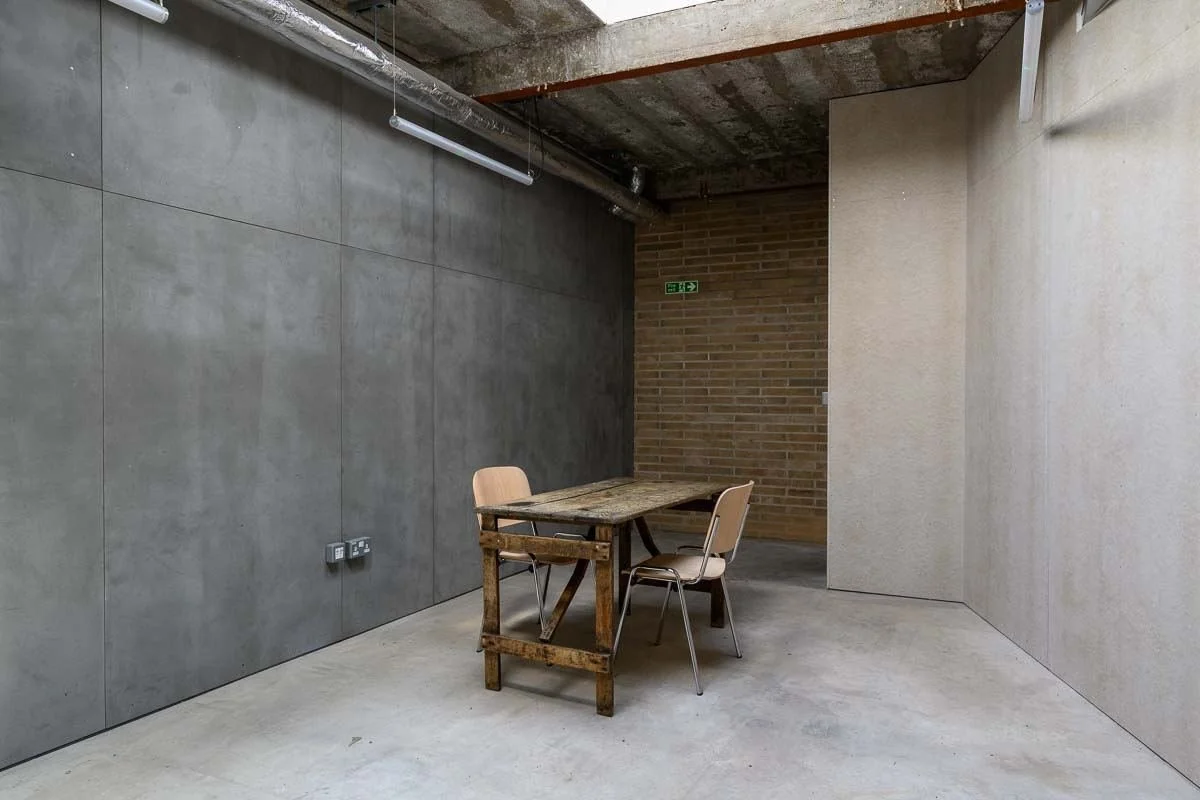 Studio Two with concrete walls, brick and a workbench