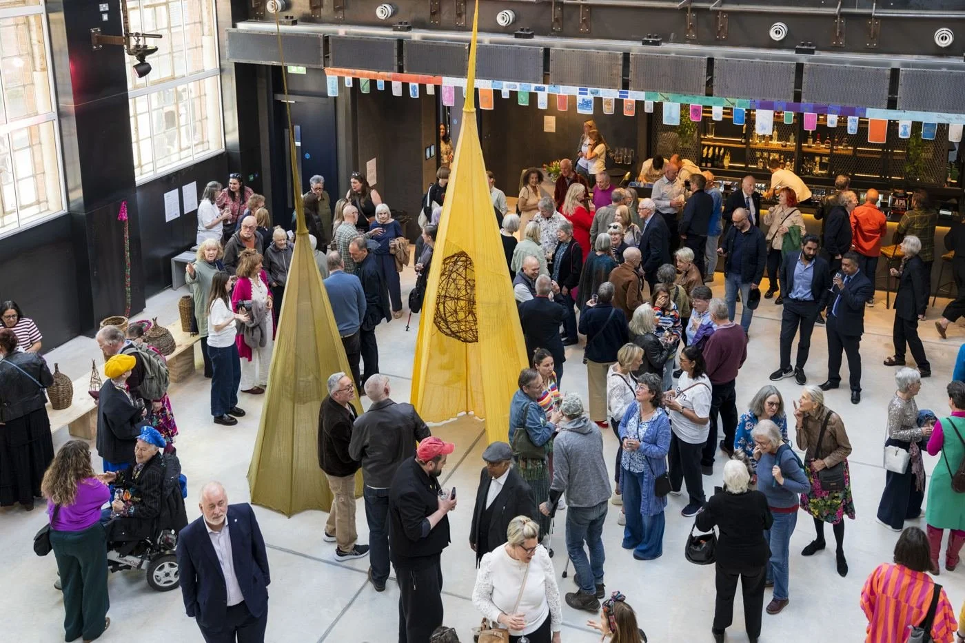 A crowd gathered in the Main Hall under bunting and banners