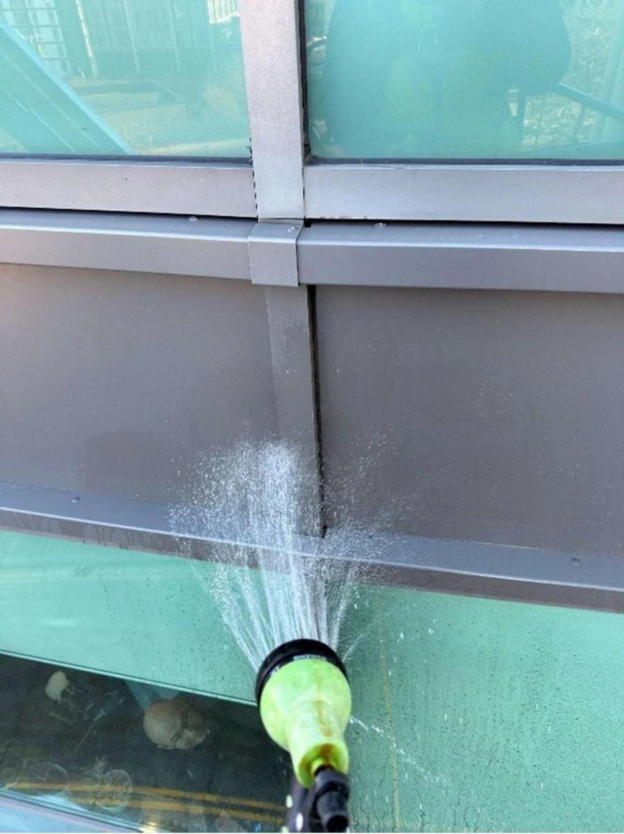 Hose test being carried out to a cruciform junction on the curtain walling