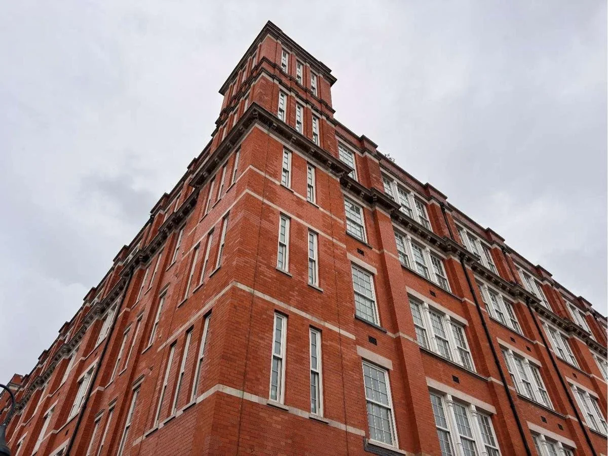Red-brick corner of the Grade II listed Islington Square Block A, looking up