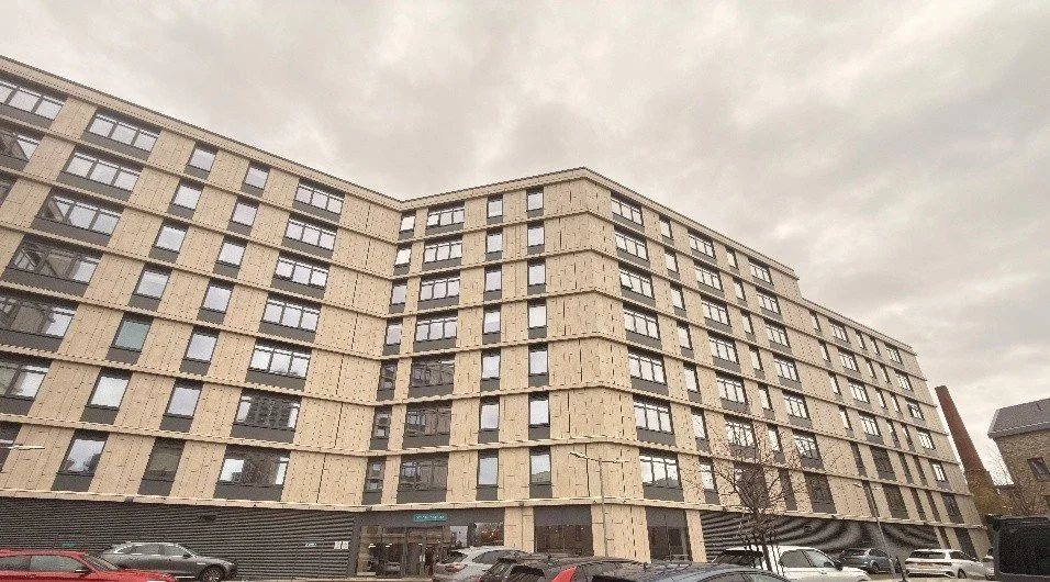 One Vesta Street, a nine-storey residential block clad in reconstituted stone panels, Manchester