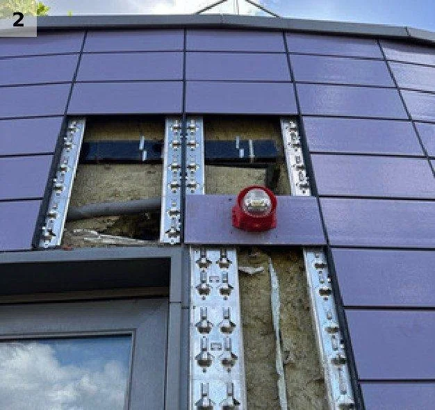 Terracotta tiles removed to expose the cavity, insulation and cavity barrier behind the rainscreen