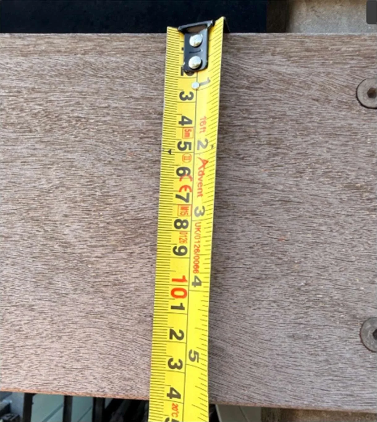 Tape measure across a timber plank of the screen cladding, recording its 140 mm face height