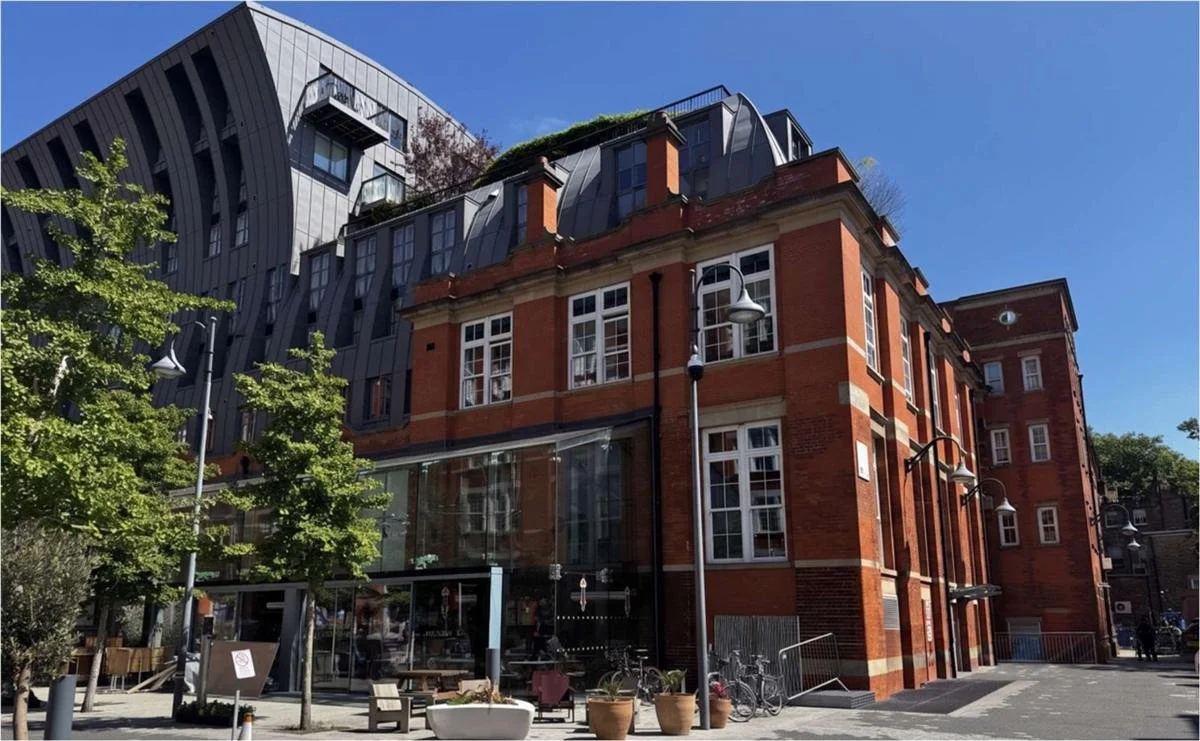 Islington Square Block B: retained red-brick building with zinc standing seam extension above