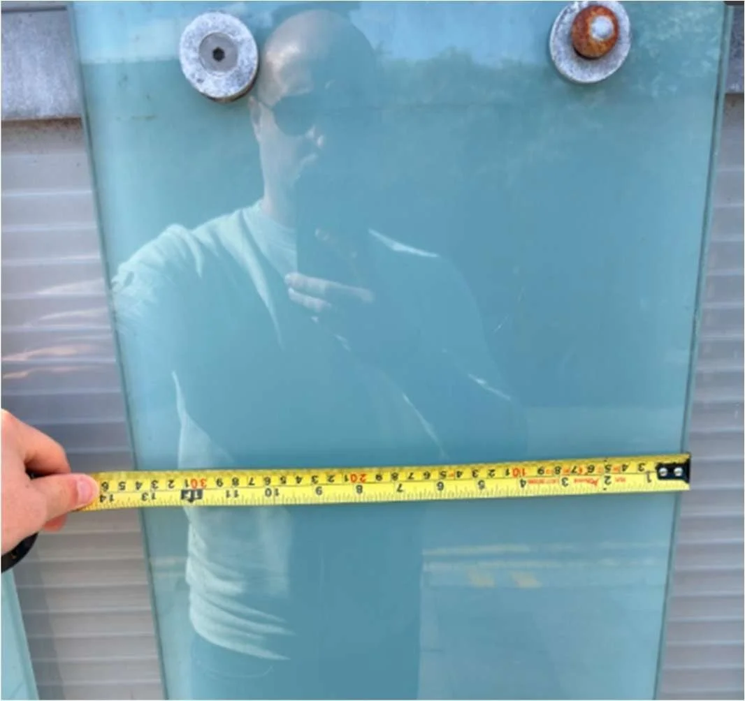 Tape measure across a glass fin of the brise soleil, recording its 340 mm width