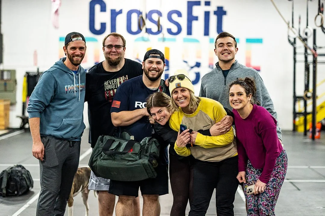 A smiling group together inside the Frostbite gym