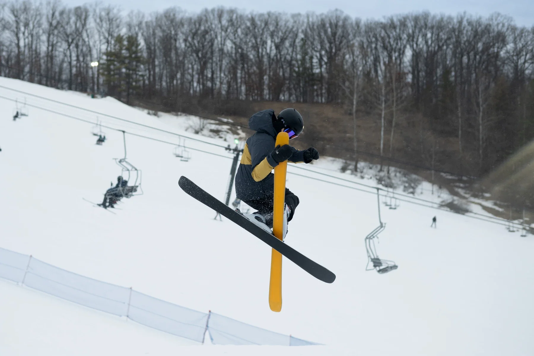 Skier crossing skis in a terrain park jump