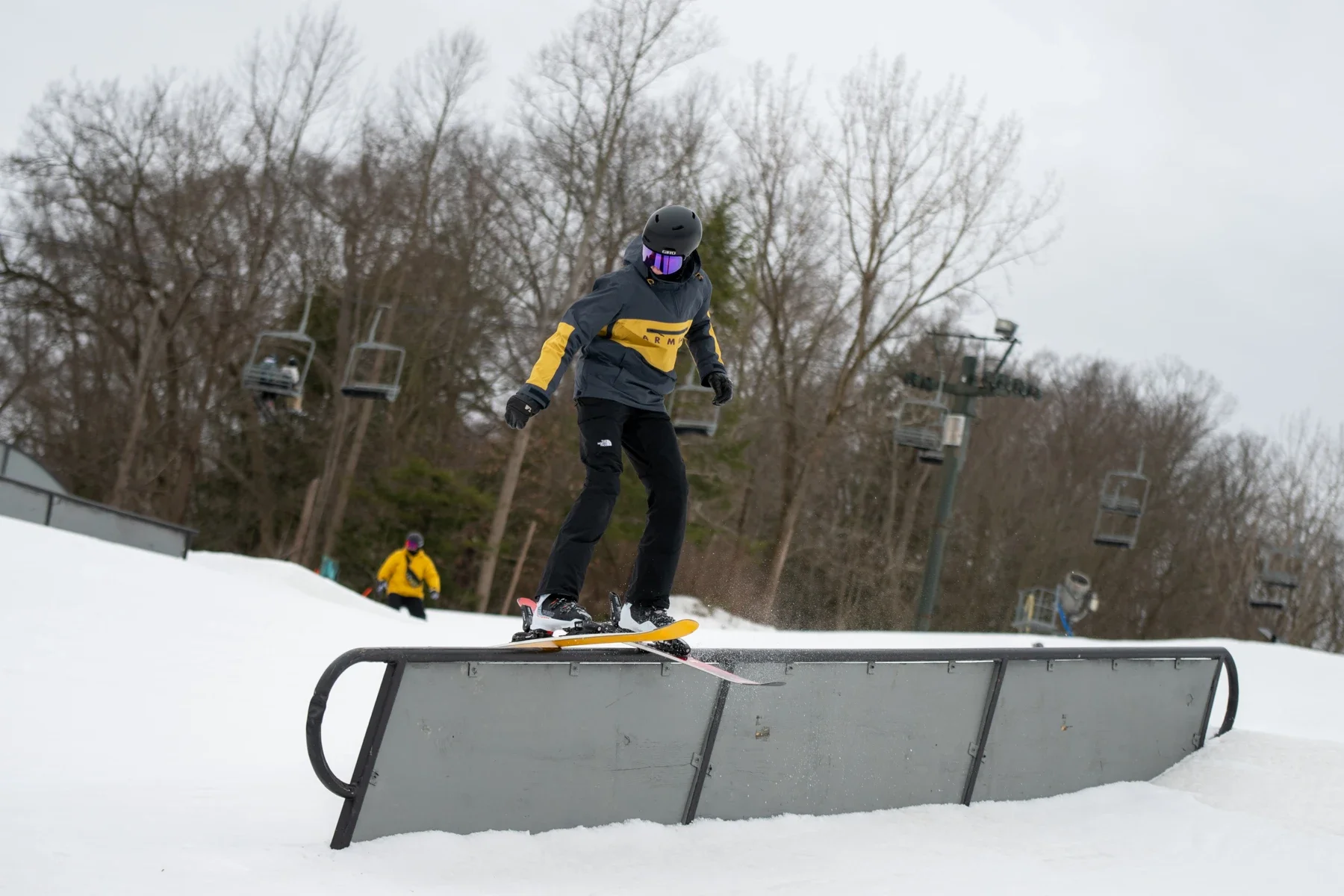 Skier balancing on a terrain park rail