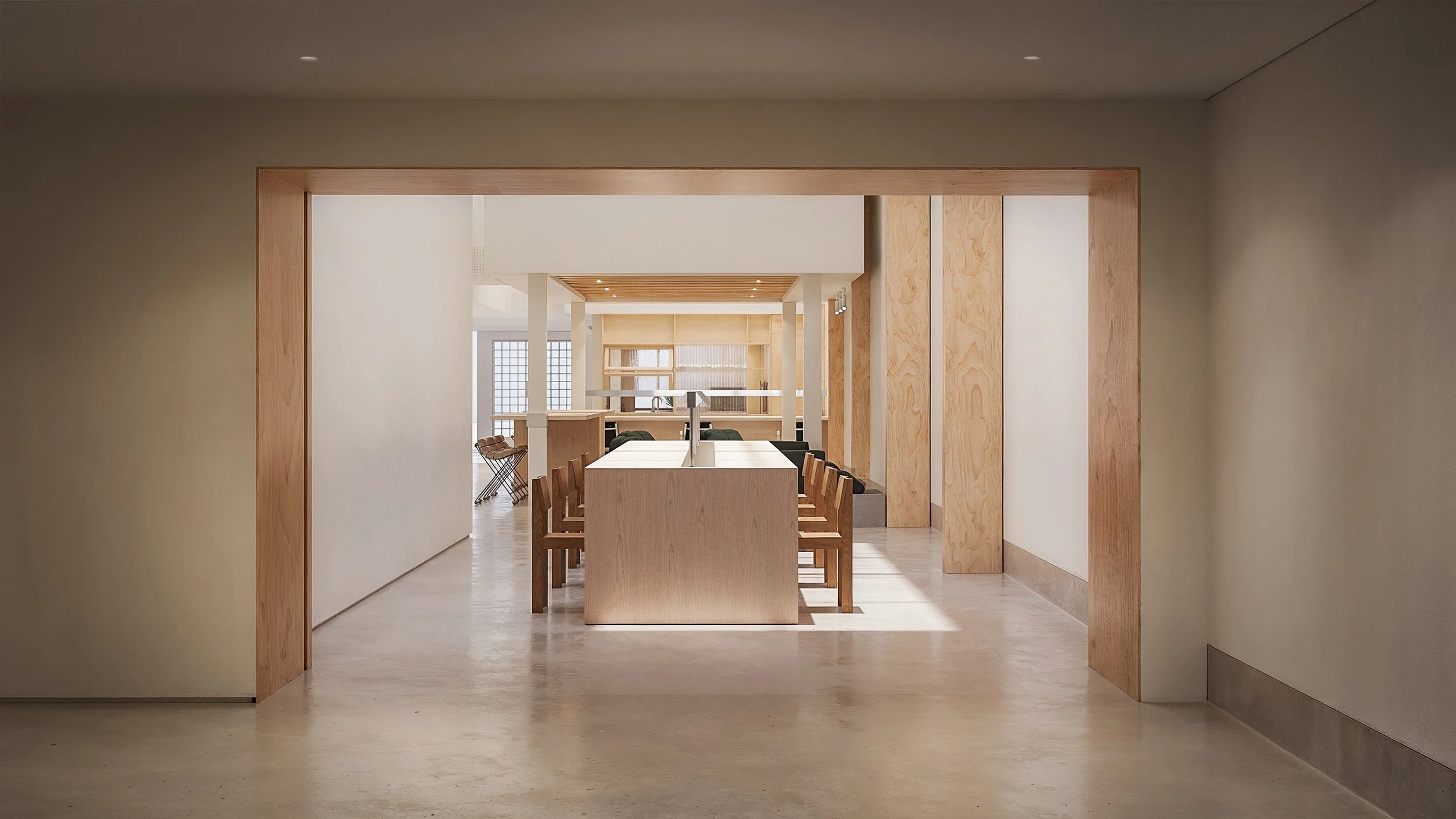 Bay Street Office — long work table framed by a timber-lined opening, Arts District, Downtown Los Angeles