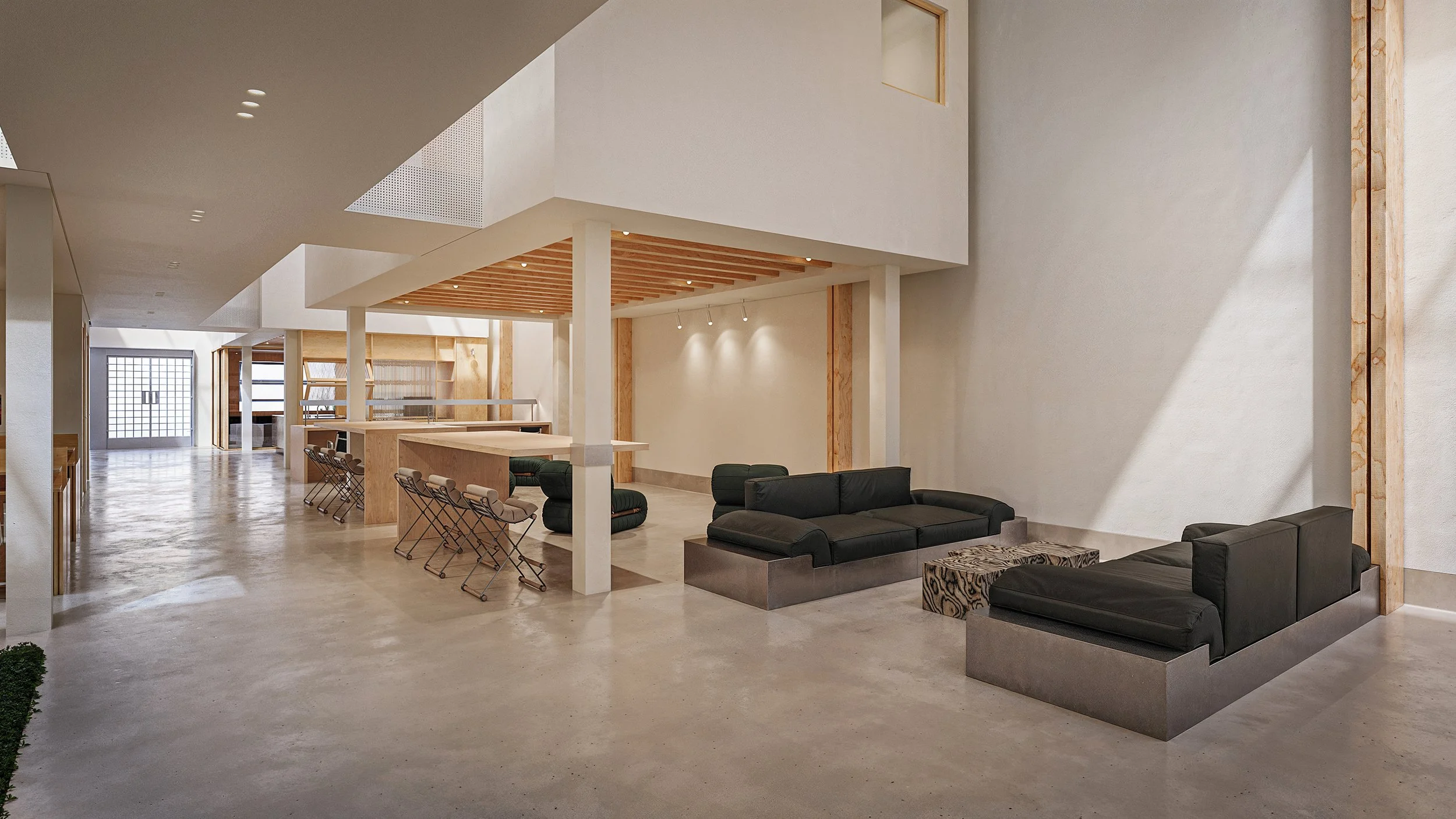 Bay Street Office — double-height lounge beneath the floating mezzanine, Arts District, Downtown Los Angeles