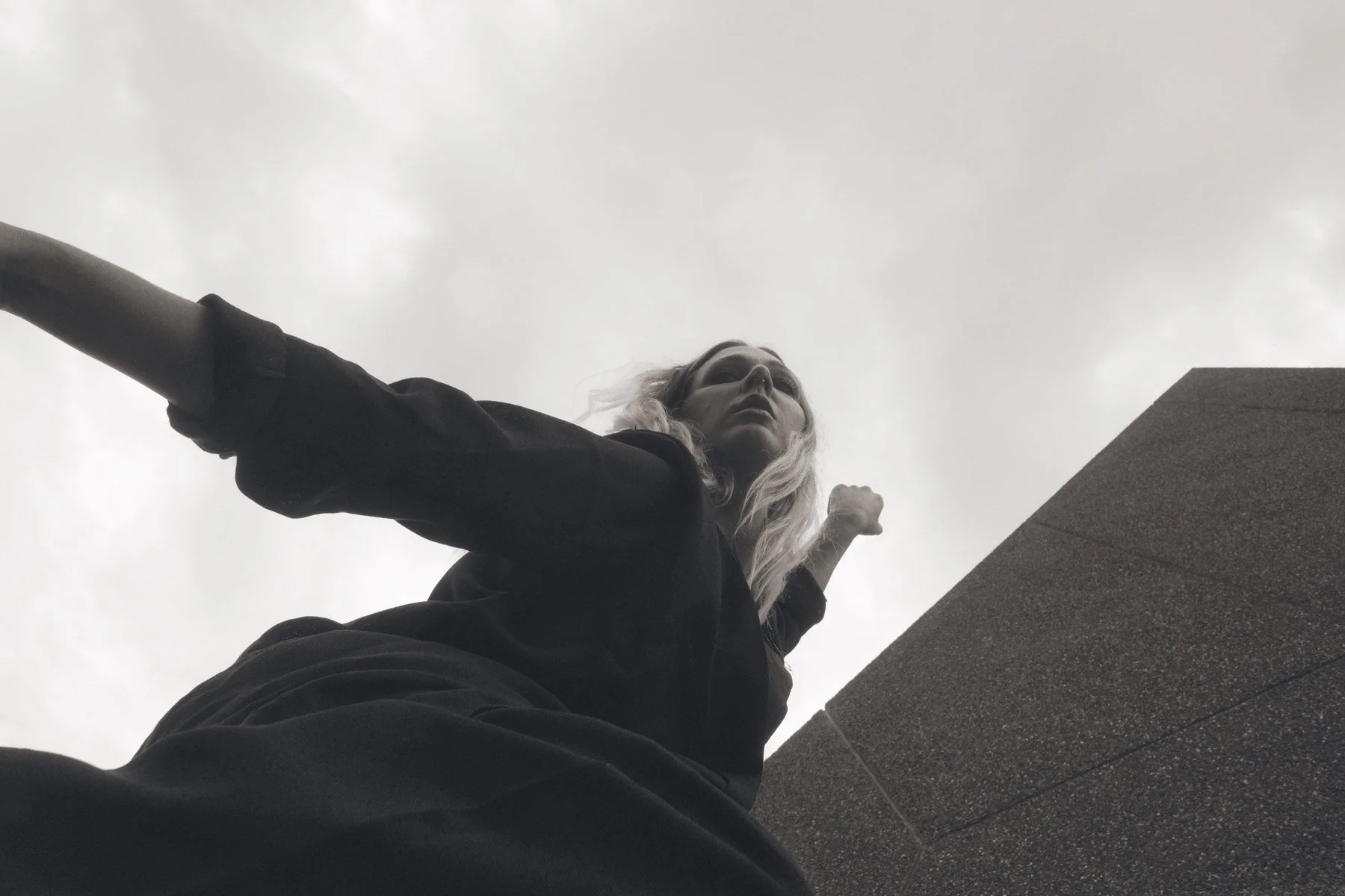 Francesca extending her arms in a striking architectural movement portrait