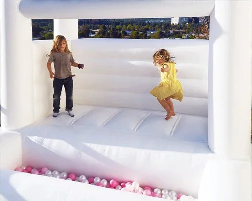 Compact pastel bounce house for toddlers — soft and photo-friendly design for small outdoor parties