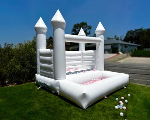 White bounce house with pink and white ball pit — perfect for 1st birthday parties and backyard celebrations