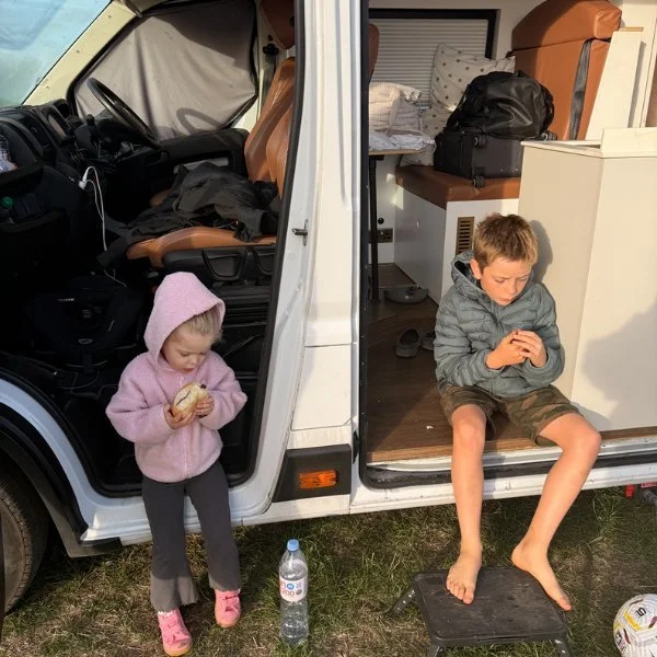 Kids sitting on the campervan step