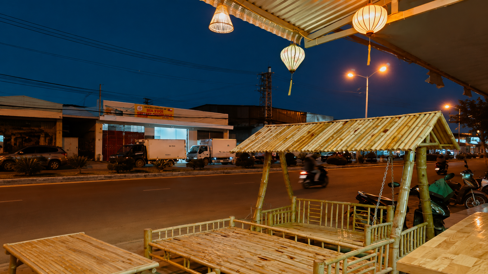 Bamboo furniture and woven pendant lanterns in a Vietnamese restaurant, photographed in the evening with warm ambient lighting