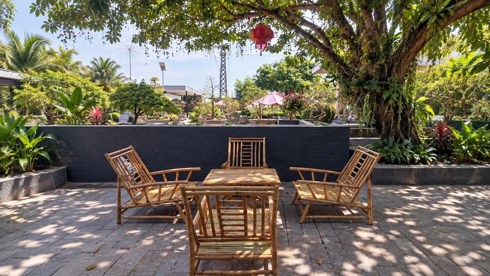 Bamboo dining furniture on an outdoor café terrace with tropical landscaping