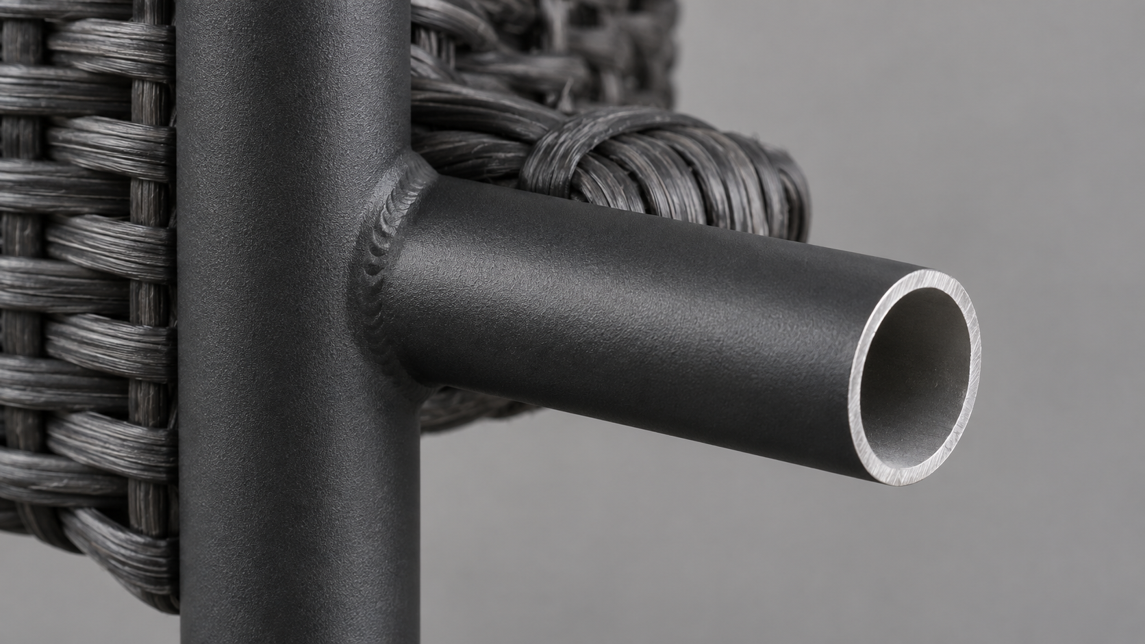 Close-up of a powder-coated aluminum furniture frame joint showing weld quality and wall thickness