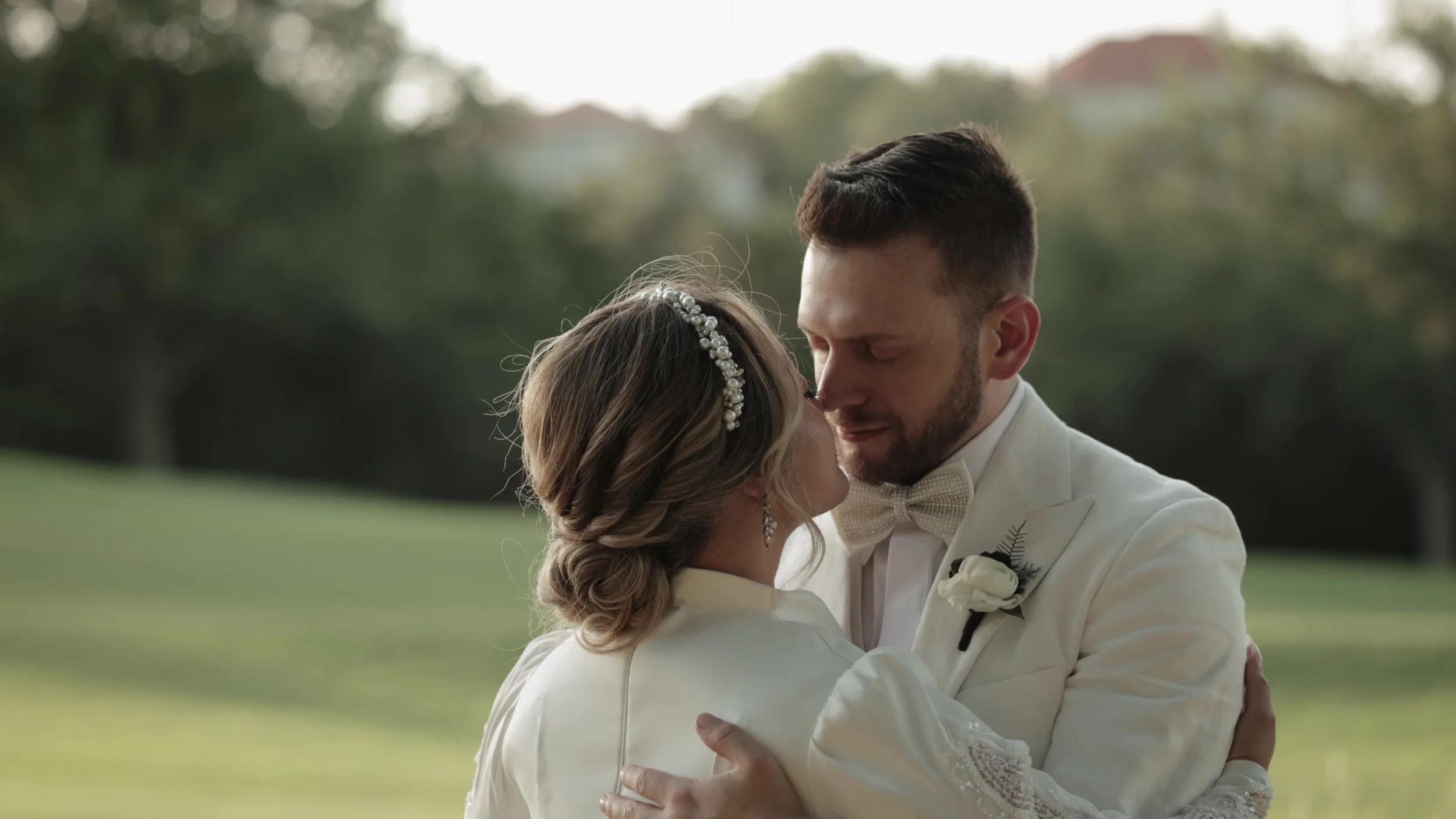 Tight outdoor embrace of Keely and Jay against Hill Country green at Barton Creek Austin