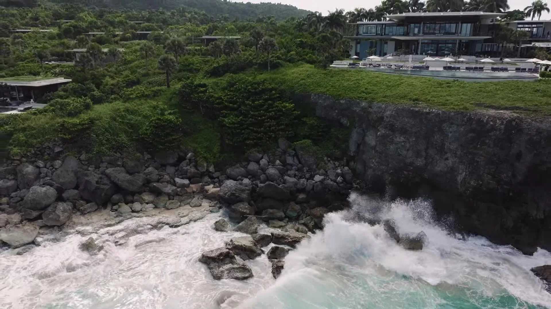 Wide aerial of Amanera on the cliff with crashing Dominican Republic waves