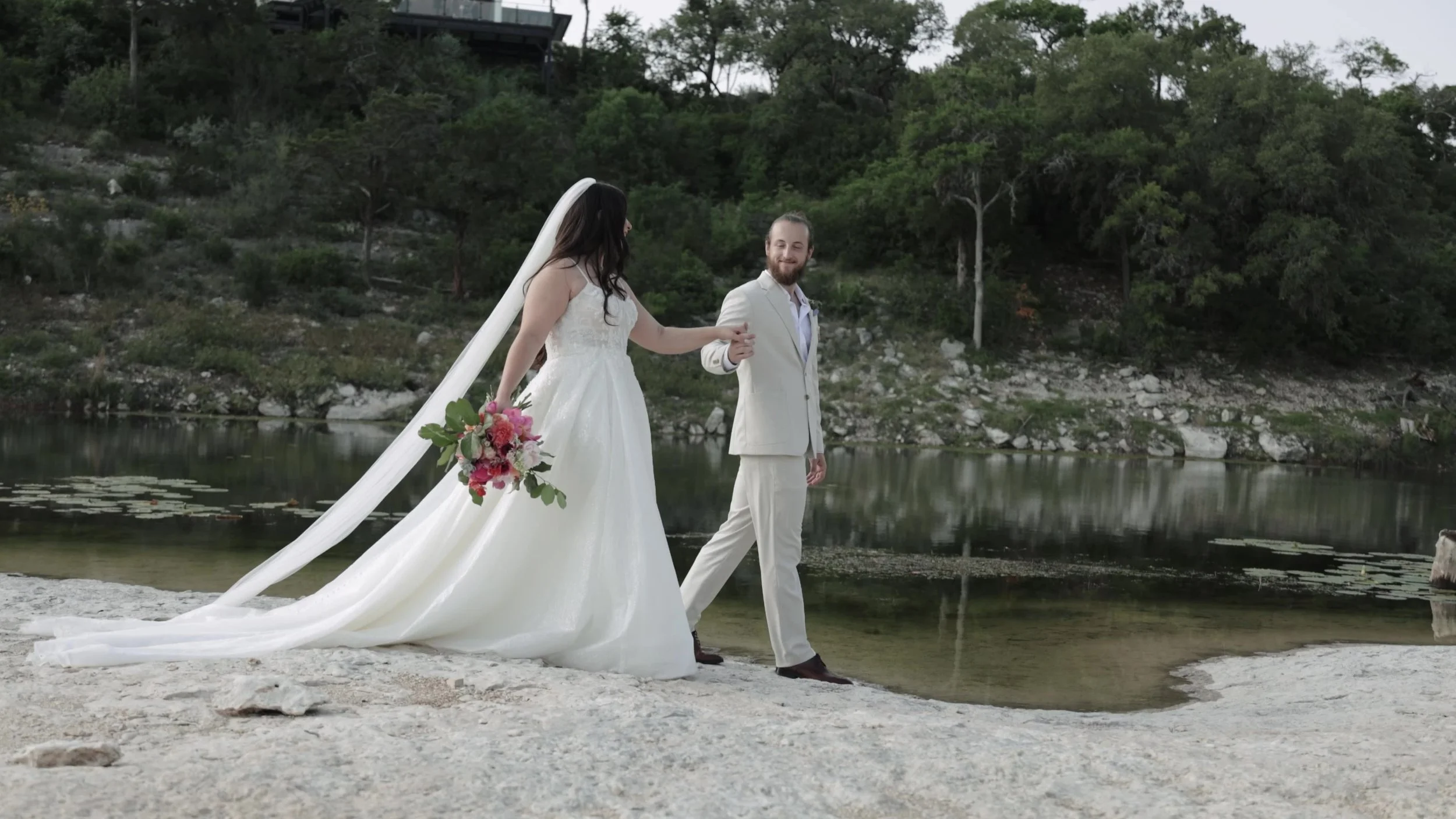 Peter and Kiyara walking the limestone water edge at Videre Estate near Austin Texas