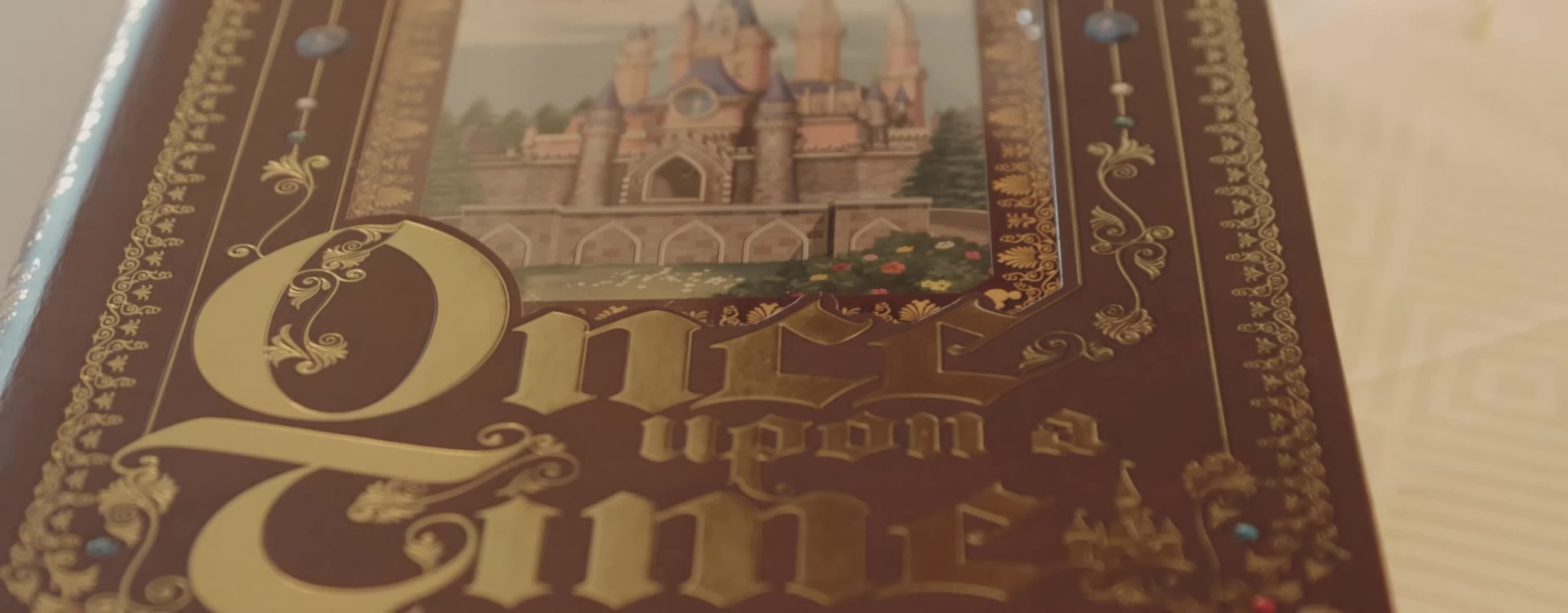 Maroon Once Upon a Time storybook with gold lettering and a castle illustration on the cover