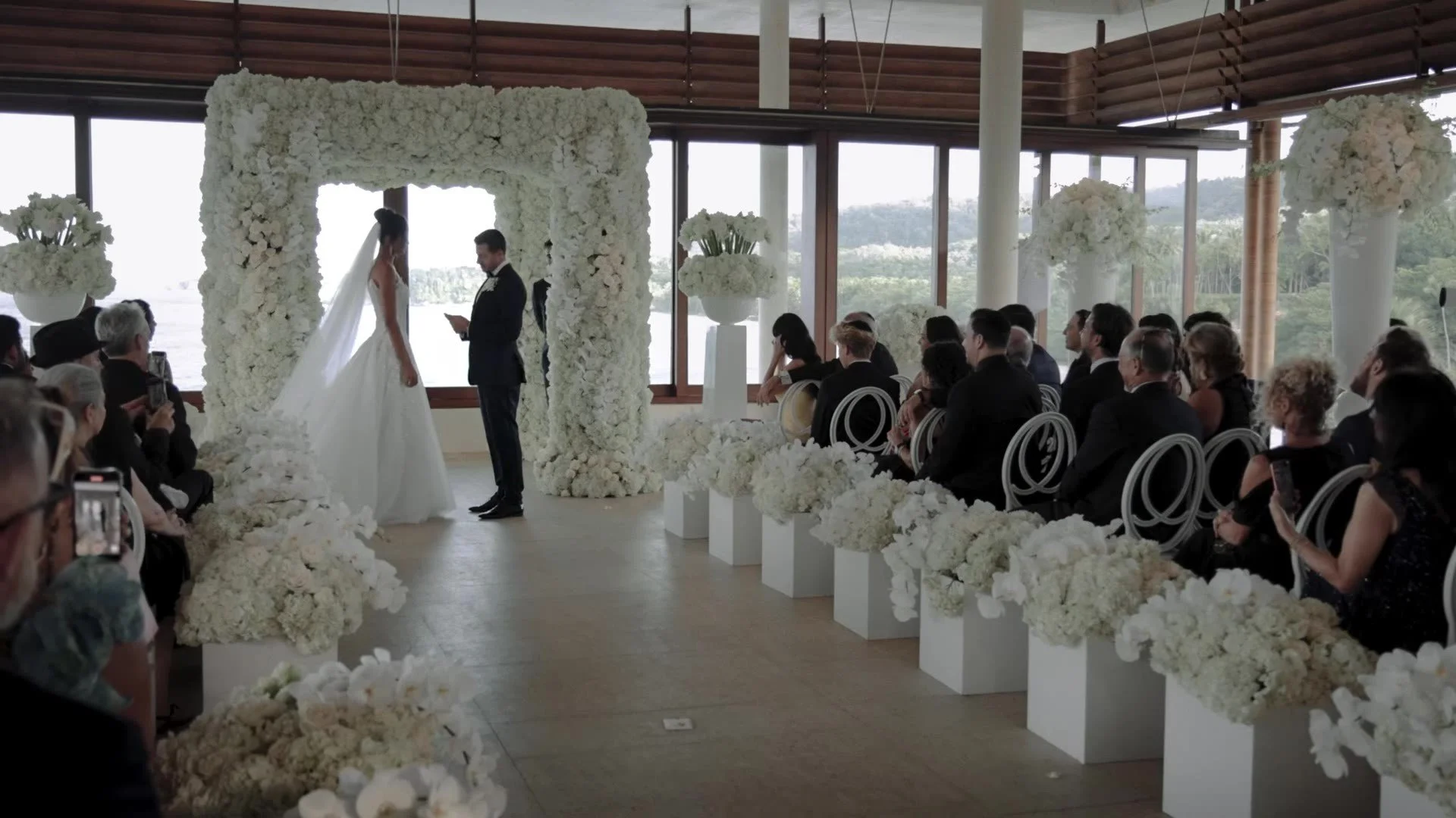Daniela and Adam under a white floral arch at Amanera Dominican Republic