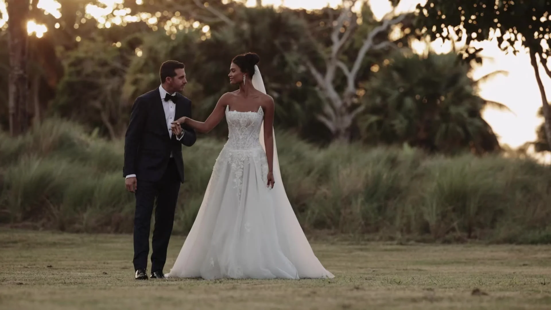 Daniela and Adam walking hand in hand at golden hour Amanera Dominican Republic