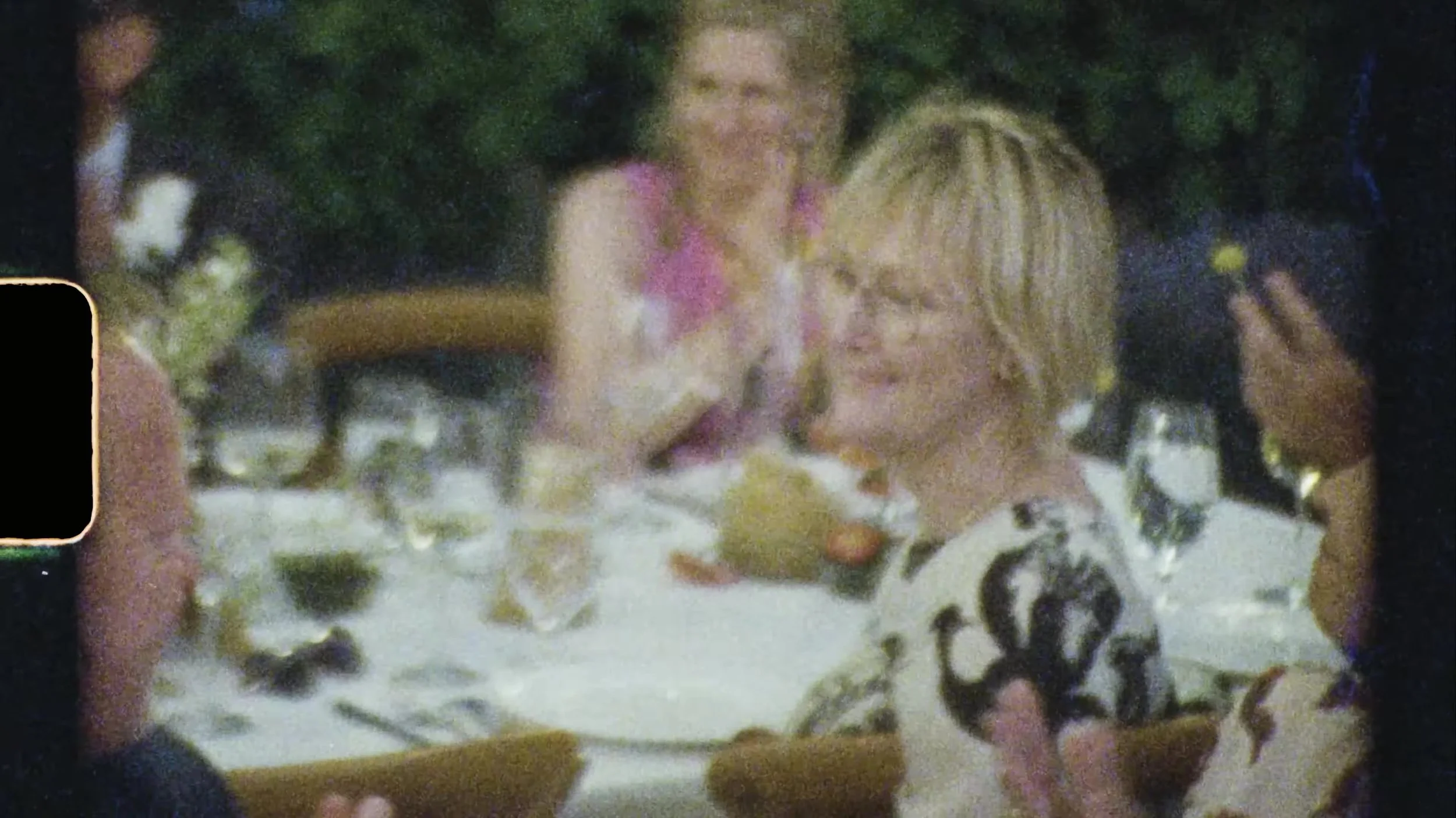 Guests laughing at a decorated reception table at Camp Lucy Vineyards in Austin, Texas