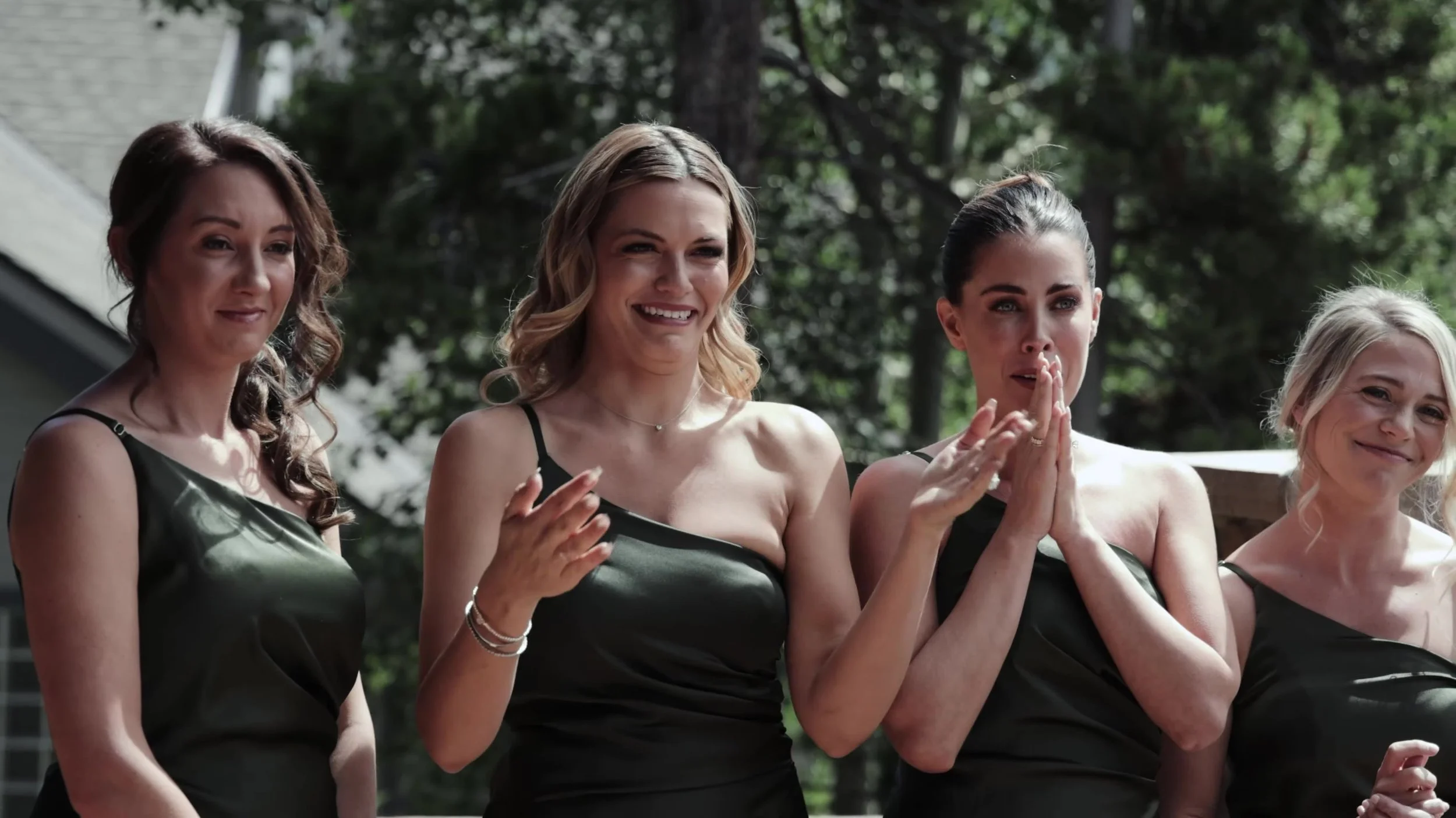 Bridesmaids in forest green dresses during a Breckenridge Colorado wedding ceremony