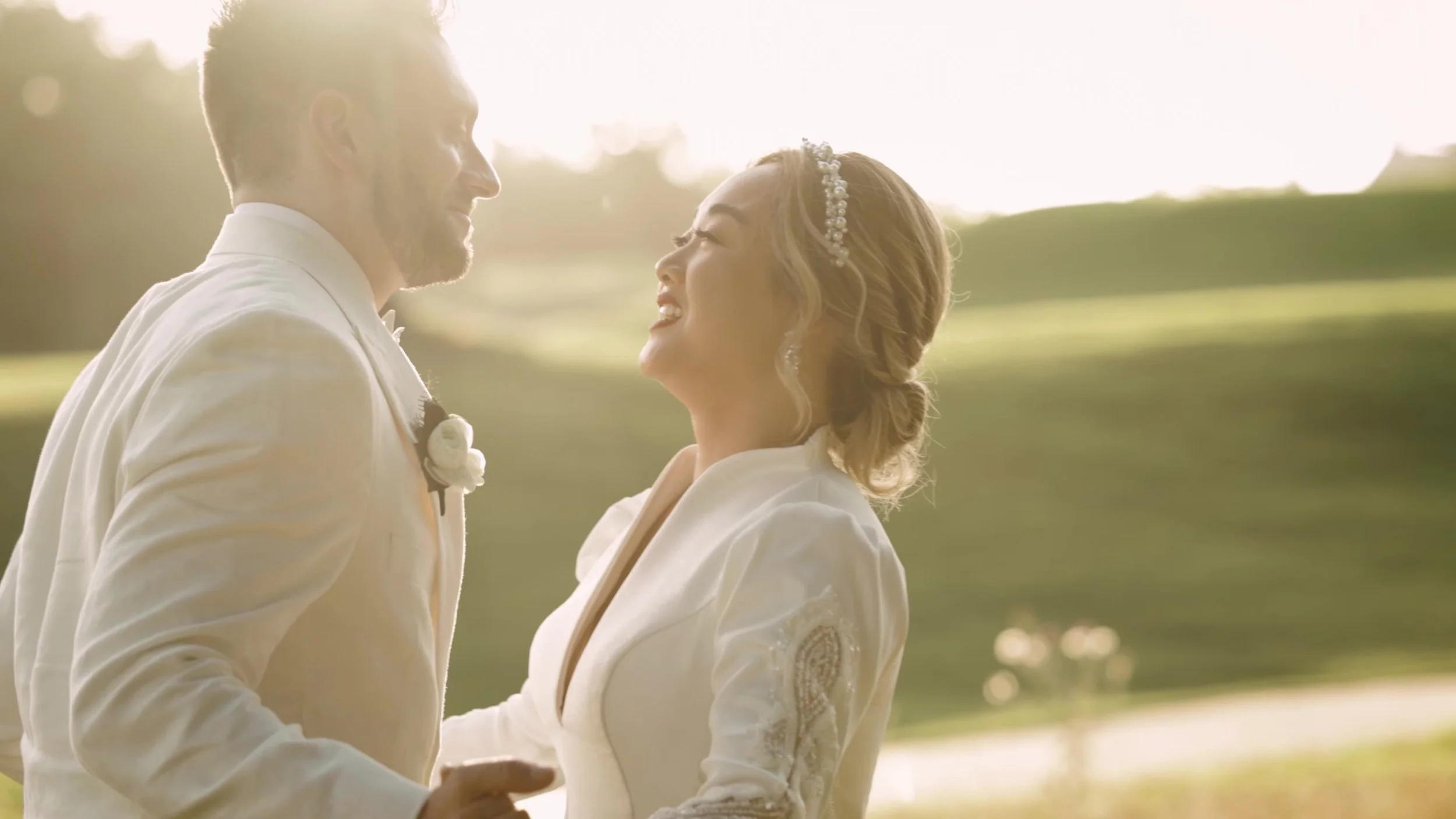 Keely and Jay smiling face to face in golden hour light at Barton Creek Country Club in Austin