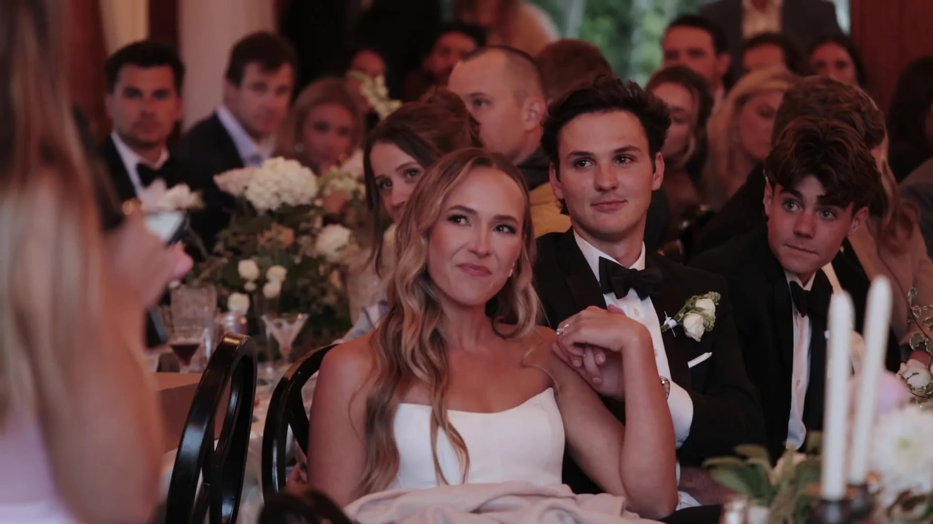 Becca and Colton seated at their reception table at Crested Butte Wedding Garden in Colorado